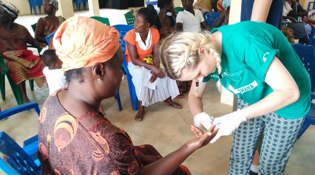 Projects Abroad nursing volunteer is taking a blood sample in Ghana during her internship.
