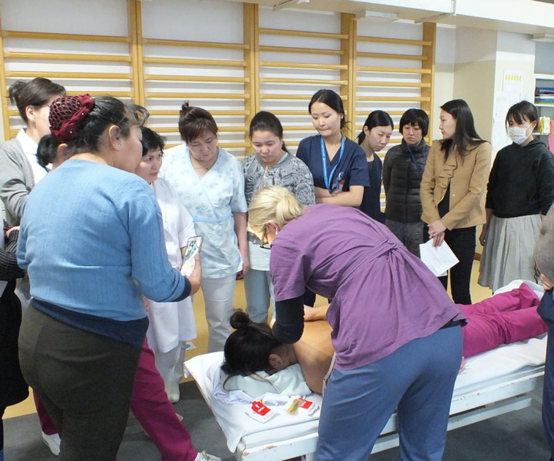 A professional physical therapist volunteering in Mongolia runs a workshop for local medical staff.