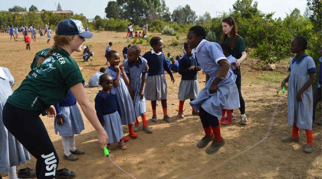 Teenage Projects Abroad care volunteers play with children in Kenya.
