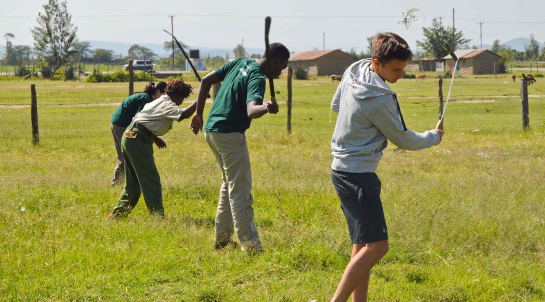 Projects Abroad conservation volunteers help remove invasive plant species in Kenya during their Giraffe and Lion conservation project.