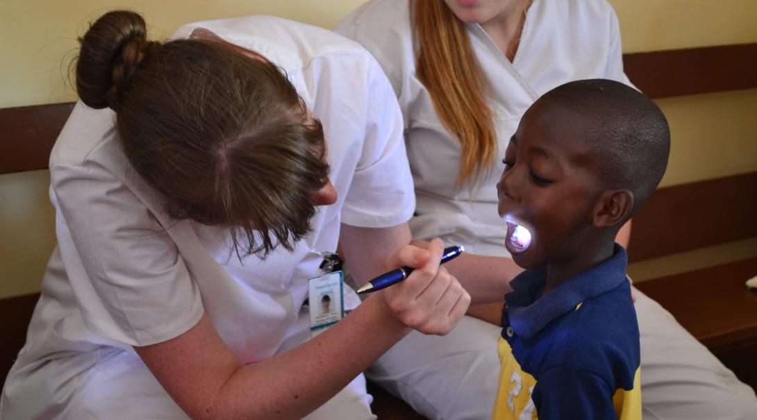 Projects Abroad volunteers doing a dentistry internship with Projects Abroad in Ghana do dental checks.