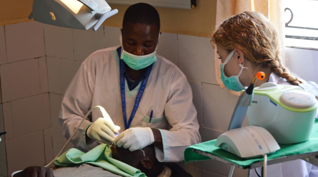 A teenage volunteer doing a medical internship with Projects Abroad in Kenya shadows a medical professional.