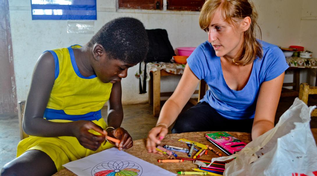 A Projects Abroad volunteer works with a local boy to record and analyze data while doing her speech internship in Ghana.