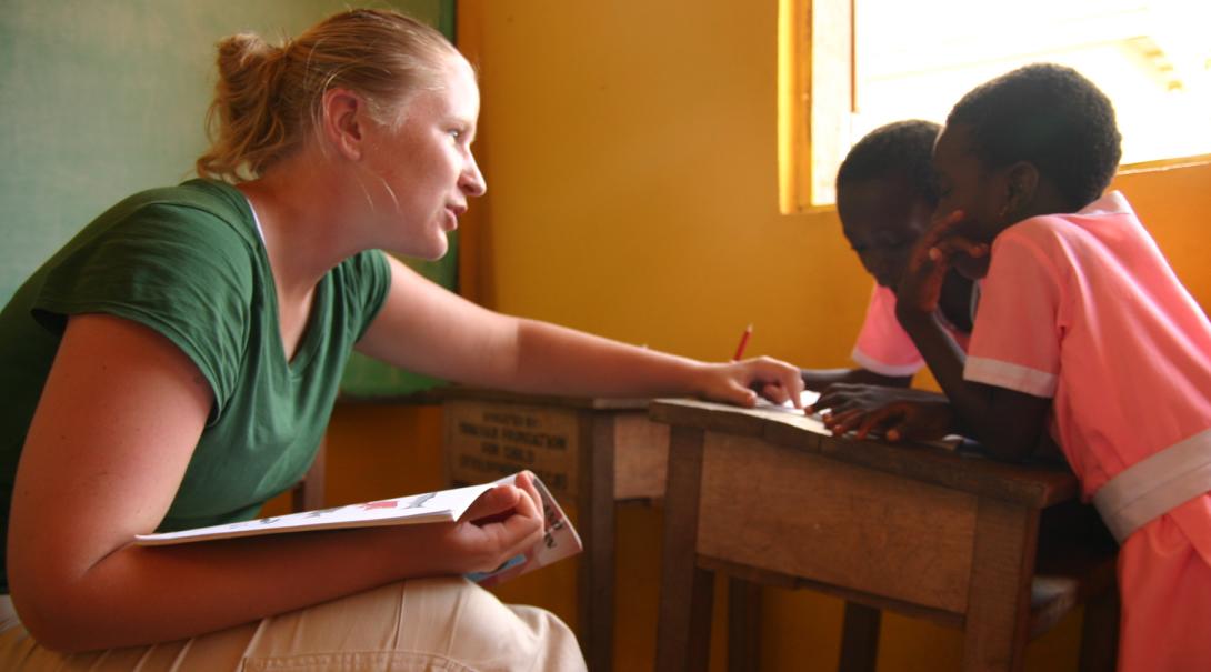 A Projects Abroad volunteer doing a speech therapy internship in Ghana works with a couple of girls.