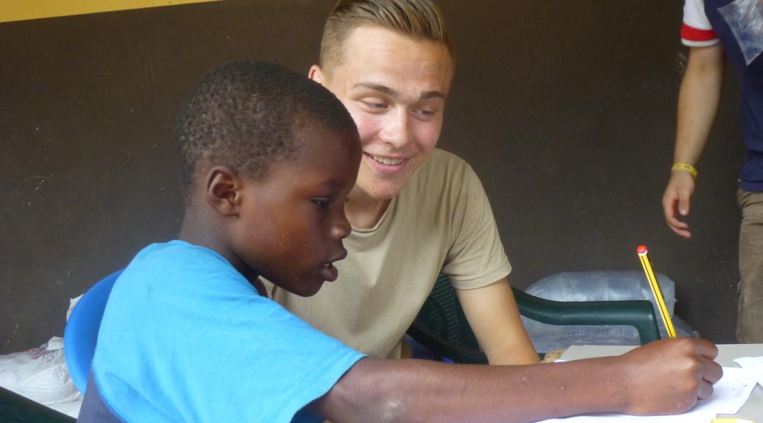 Projects Abroad volunteer helps a child to improve his speech skills through exercises in Ghana while doing his speech therapy internship.