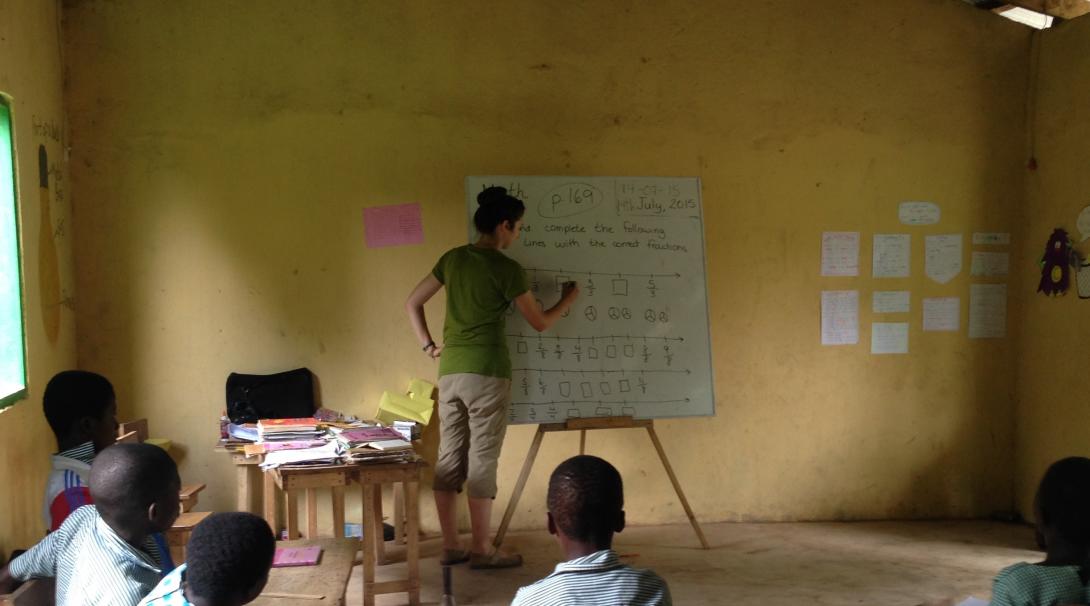 A volunteer doing a teaching English program with Projects Abroad prepares a lesson to local students in Ghana.