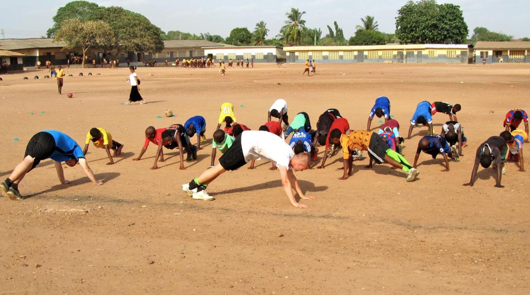 A Projects Abroad teaching volunteer gets involved in a sports lesson in Ghana.