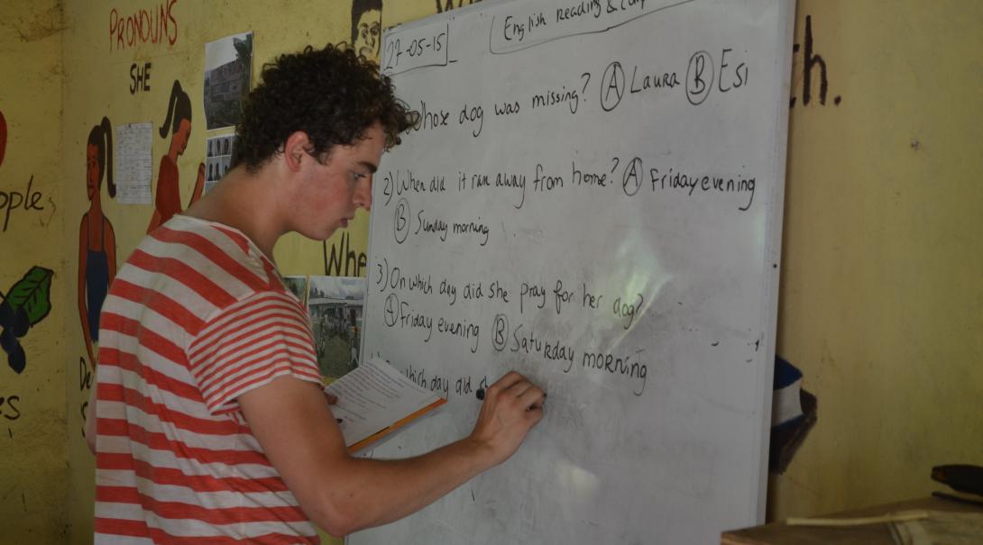 A Projects Abroad teaching volunteer prepares some English exercises for the class in Ghana.