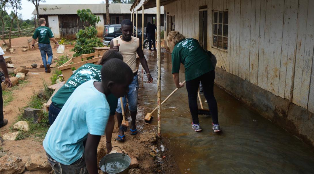 Some teaching volunteers help staff from a local school in Kenya to clean the facilities during their projects with Projects Abroad.