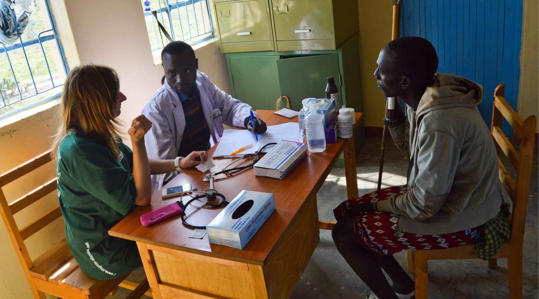 A Projects Abroad volunteer helps a local doctor in Kenya to assess a patient during her Occupational Therapy internship.