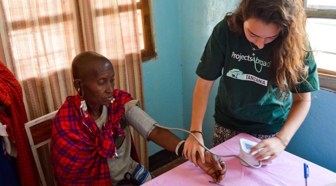 A female Public Health intern measures a patient’s blood pressure levels in Tanzania.