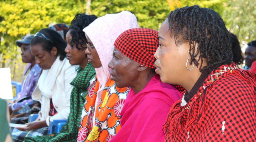 Tanzanian women listen to a presentation about human rights given by Projects Abroad interns. 