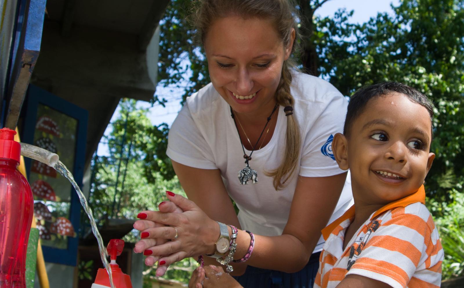 A Projects Abroad volunteer is washing her hands while volunteering abroad.